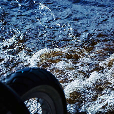 bicycle wheel on the background of the riverの写真素材