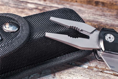 Pliers and a black case on a wooden backgroundの写真素材