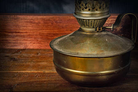 Old kerosene lamp on a wooden backgroundの写真素材