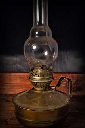 Old kerosene lamp on a wooden backgroundの写真素材