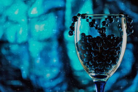 champagne glass with New Year's blue beadsの写真素材