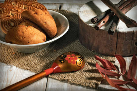 cookies, spoon with a pattern and cloth on a wooden tableの写真素材