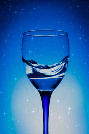 wine glass of water on blue backgroundの写真素材