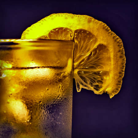 cocktail with ice and lemon in a misted glassの写真素材
