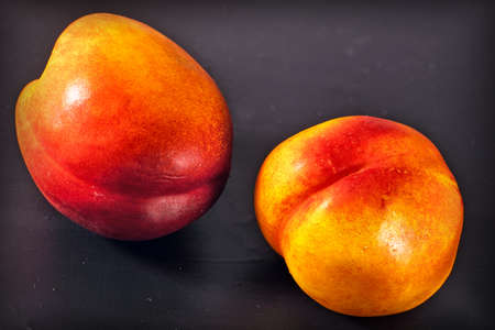 two nectarines on black backgroundの写真素材