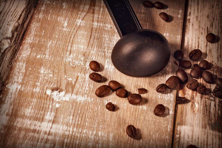 Measuring spoon for coffee maker and coffee beans on wooden backgroundの写真素材