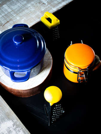 Grater for food and saucepan on a black backgroundの写真素材