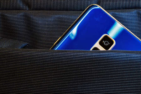 blue mobile phone with a camera in a bag pocketの写真素材