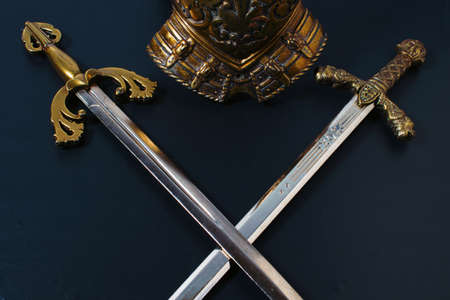 two crossed knightly swords on a black background