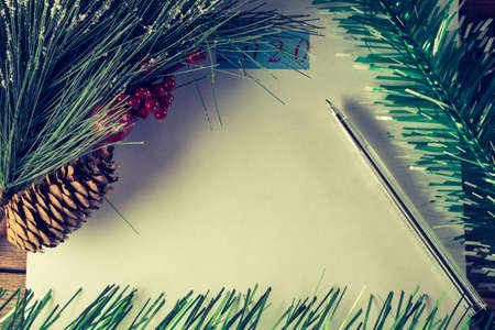 Christmas and New Year holiday background with spruce branches and red berries. Christmas card, top view. Place for text.の写真素材