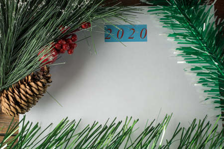 Christmas and New Year holiday background with spruce branches and red berries. Christmas card, top view. Place for text.の写真素材