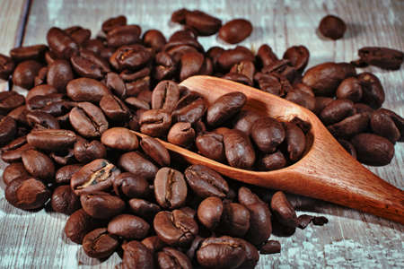 coffee beans and spoon on wooden backgroundの写真素材