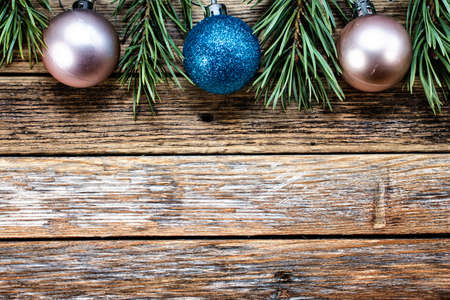 Christmas balls and pine branches on wooden background. Winter holiday concept. View from above. Copy spaceの写真素材
