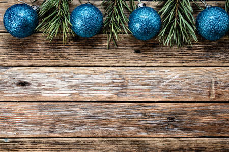 Christmas blue balls and pine branches on wooden background. Winter holiday concept. View from above. Copy spaceの写真素材