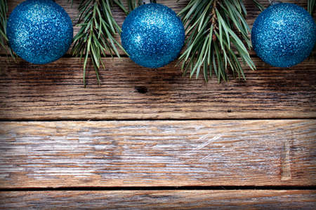 Christmas blue balls and pine branches on wooden background. Winter holiday concept. View from above. Copy spaceの写真素材