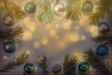 Christmas background with pine branches, bright balls and golden bokeh. Holiday concept. View from above.の写真素材