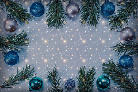 Christmas background with pine branches, bright balls and multi-colored lights. Holiday concept. View from above.の写真素材