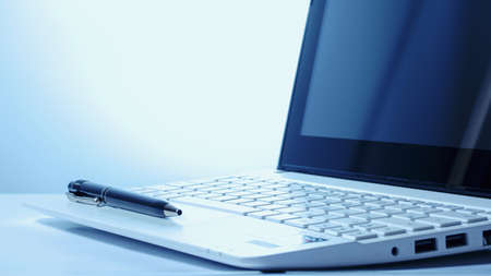 Open notebook and black pen on a white background. Back light. Business conceptの写真素材