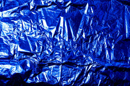 Background with blue wrinkled foil wrapping paperの写真素材