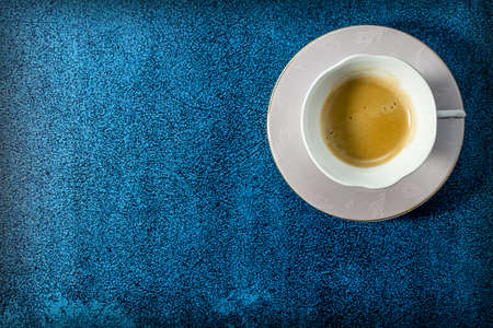 cup of coffee on blue backgroundの写真素材