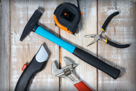 Composition of different tools on a wooden background. View from above.の写真素材