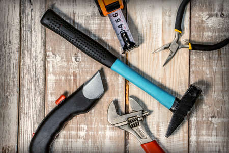 Composition of different tools on a wooden background. View from above.の写真素材