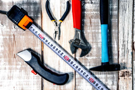 Composition of hand tools on a wooden background. View from above.の写真素材