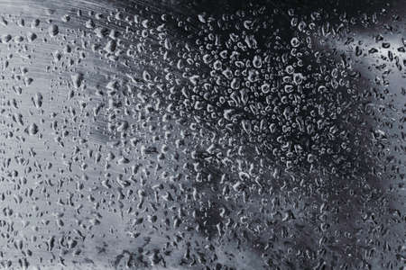 Abstract background with water drops on a silver metal sheet.の写真素材