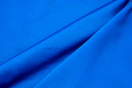 Dark blue colored fabric background. Beautiful satin silk textured fabric.の写真素材