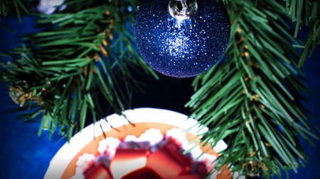 Christmas decoration and gifts on a background of green spruce branches. Winter holidayの写真素材