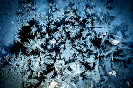 Abstract background with winter frosty patterns on the windowの写真素材