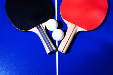 Rackets and balls for table tennis on a blue background with white linesの写真素材