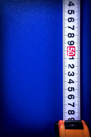 Background with tape measure on a blue backgroundの写真素材