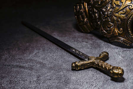 Knight's sword and armor on a gray granite backgroundの写真素材