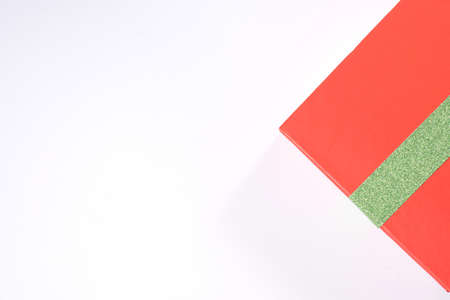 Closeup gift red box with green ribbon isolated on white backgroundの写真素材
