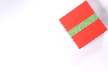 Gift red box with green ribbon isolated on white background. View from aboveの写真素材