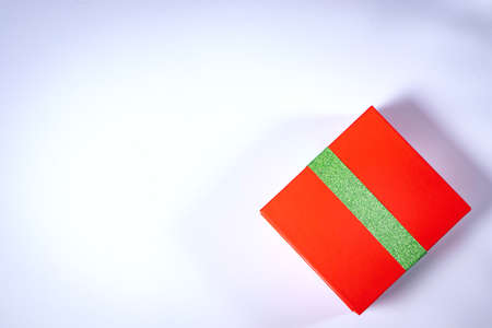 Gift red box with green ribbon isolated on white background. View from aboveの写真素材