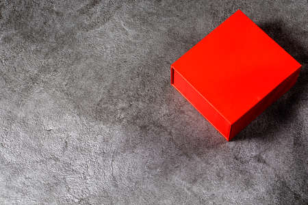 Red gift box on a gray marble background.の写真素材