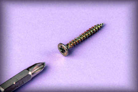 Fixing screws and bits on a purple backgroundの写真素材