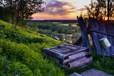 Beautiful landscape with evening river and sunbeams on the horizon.の写真素材