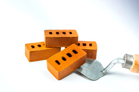 Isolated trowel and brick blocks on white background