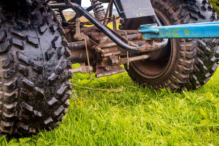 ATV wheel close up on green grass backgroundの写真素材