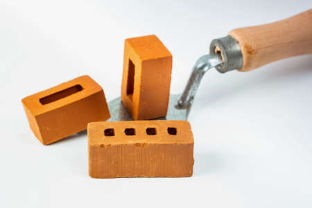 Isolated trowel and brick blocks on white backgroundの写真素材