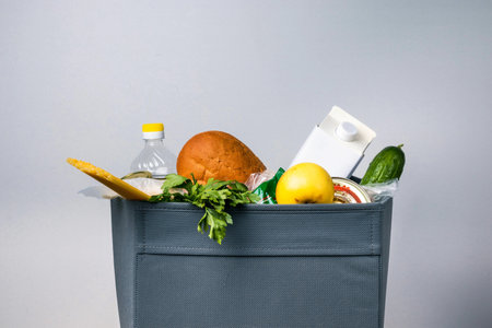 Gray box with food for delivery on a white background. Concept of helping those in need during coronavirus isolation.の写真素材