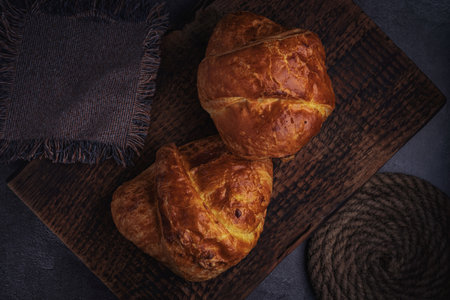 Vintage background with croissants on a stand made of old natural wood, a slide made of old rope.の写真素材