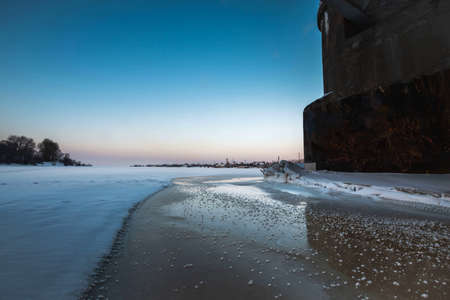 A beautiful view from under the Kuznechevsky bridge to the frozen Northern Dvina river, Arkhangelsk. Winter landscapesの写真素材