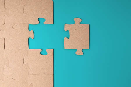 Puzzles made of cardboard on a blue background as a symbol of a business solution. Business strategy...