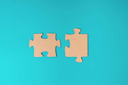 Puzzles made of cardboard on a blue background as a symbol of a business solution. Business strategy...