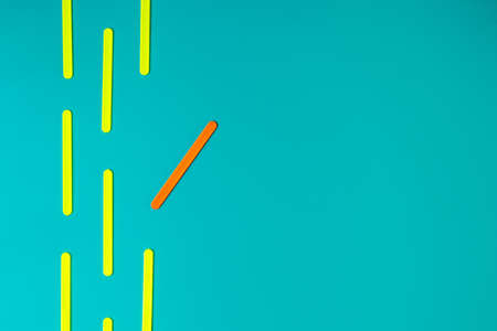 A group of yellow objects is located in one direction and one orange one deviates to the side. New ideas of creativity. Business concept of innovative solutionsの写真素材