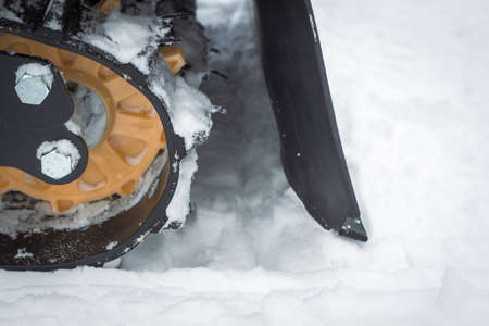 Snowmobile caterpillar in the snow close up. Winter extreme travelの写真素材